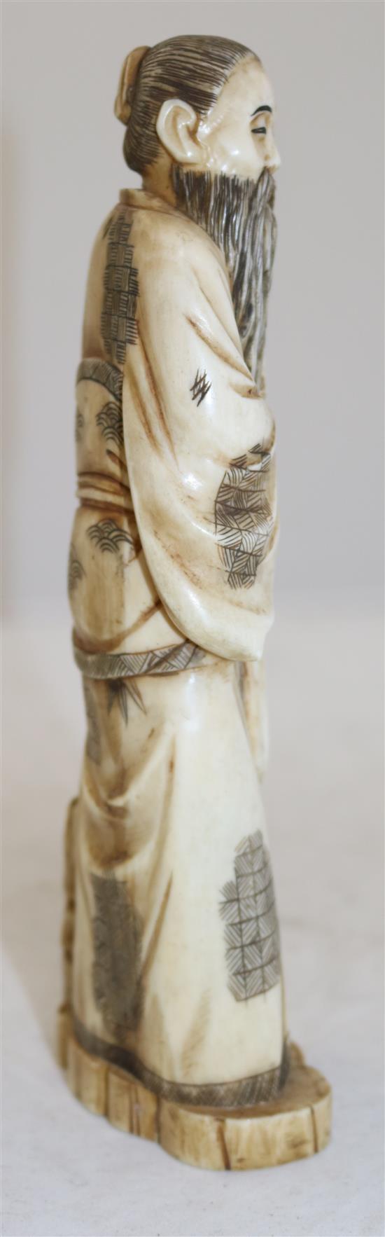 A Japanese walrus ivory figure of a man pouring water from a gourd, early 20th century, height 21cm